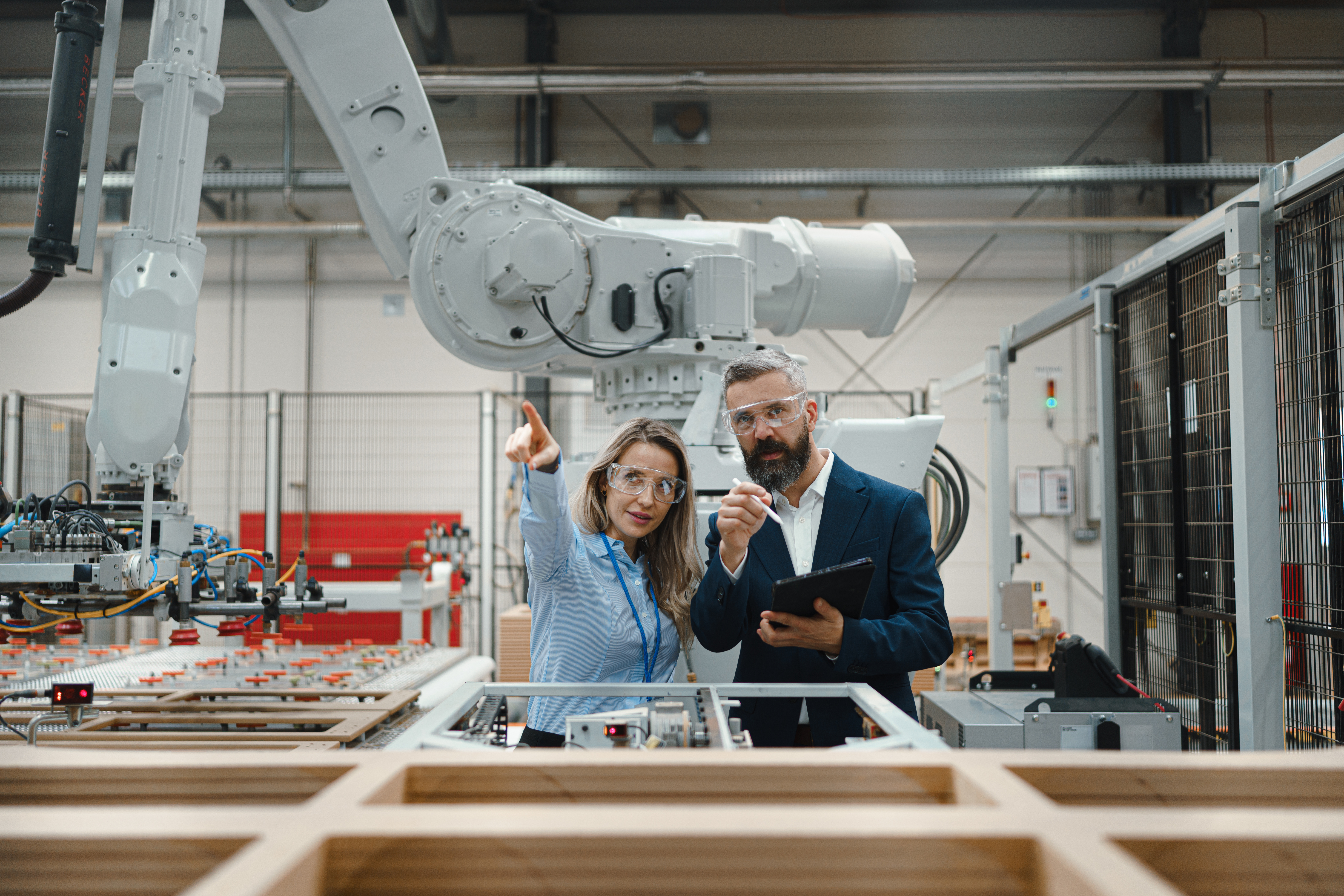 man and woman pointing in manufacturing